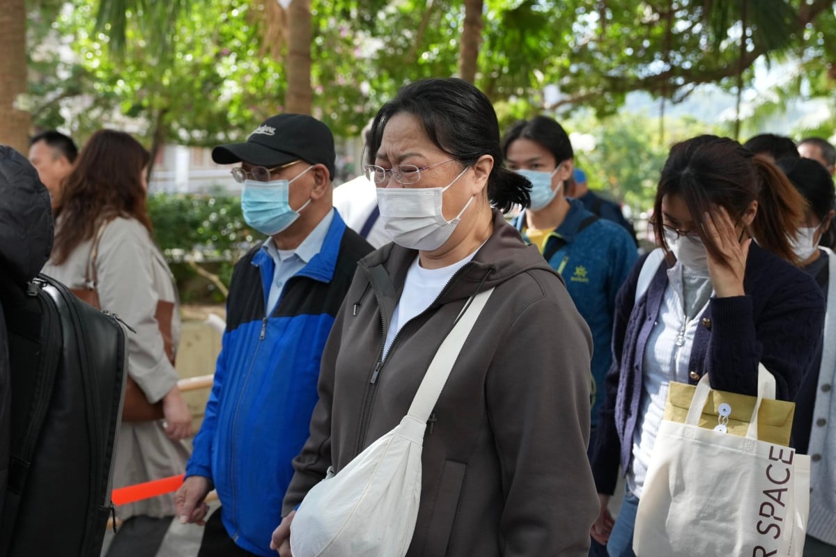 Residents queue up to identify bodies outside a community hall in Tai Po. Photo: Karma Lo