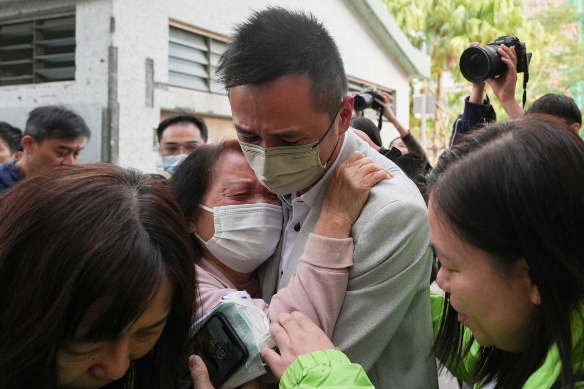 Relatives weep after identifying loved ones who perished in the fire. Photo: Eugene Lee