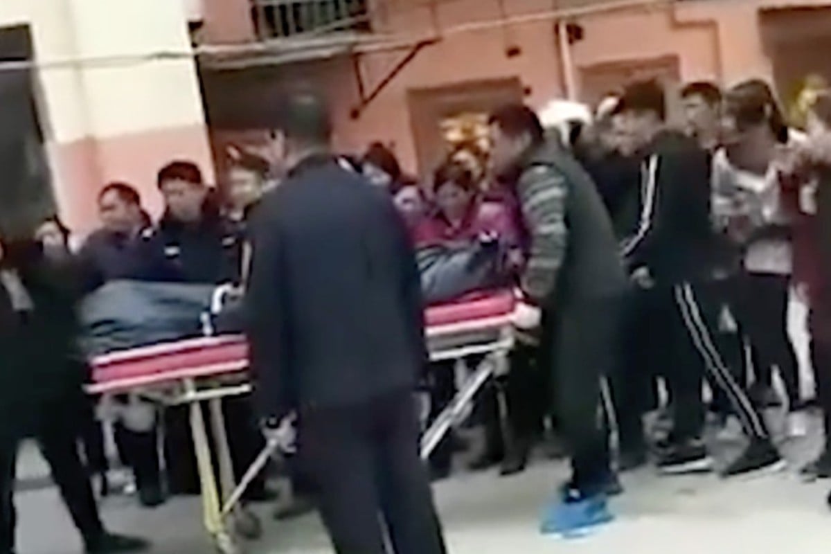 Police remove a body from property in Jianhu county, Jiangsu province, where a teenager is alleged to have killed his mother. Photo: Feng Video