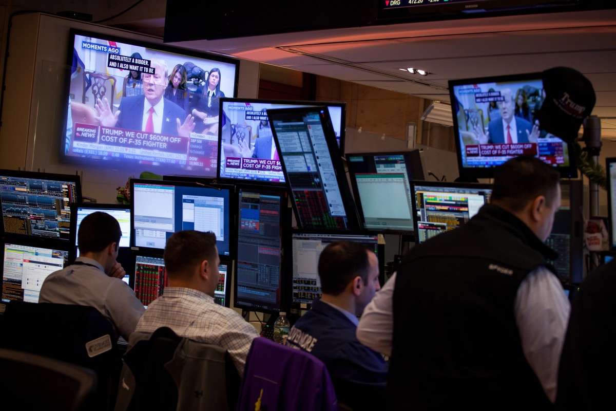 Traders work as US President Donald Trump is seen on television on the floor of the New York Stock Exchange (NYSE) in New York. Photo: Bloomberg