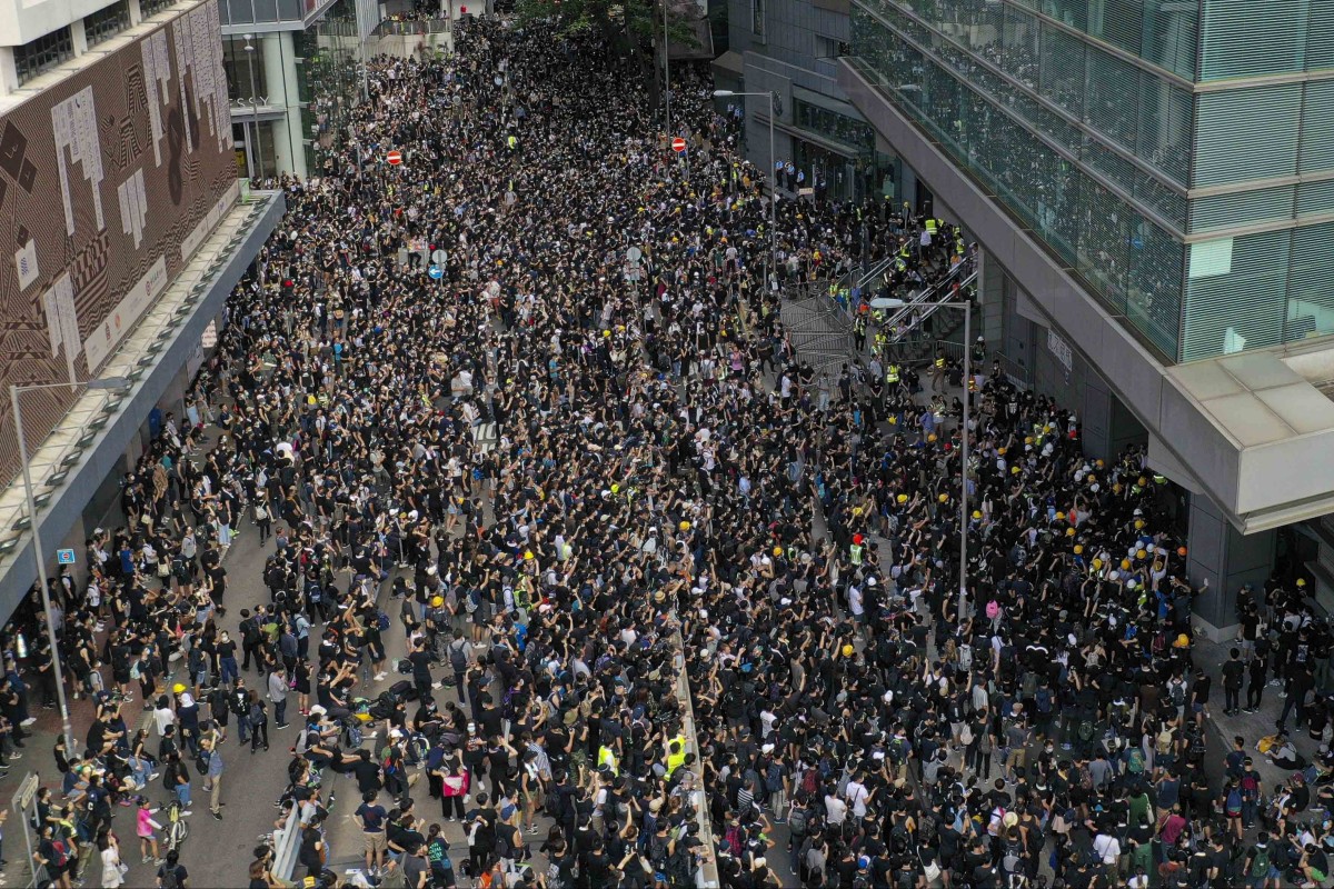 Protesters outside police headquarters in Wan Chai on Friday. Photos: Martin Chan