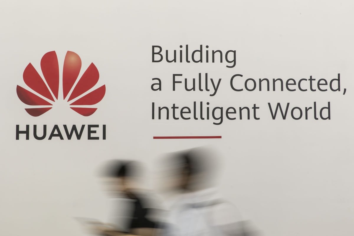 Attendees walk past a sign for Huawei Technologies at the MWC Shanghai 2019 trade show on June 27. Photo: Bloomberg