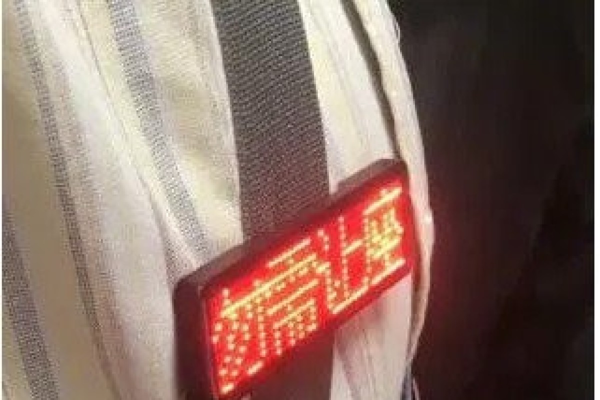 The man’s badge reading “no need to give up your seat” captured attention. Photo: Weibo