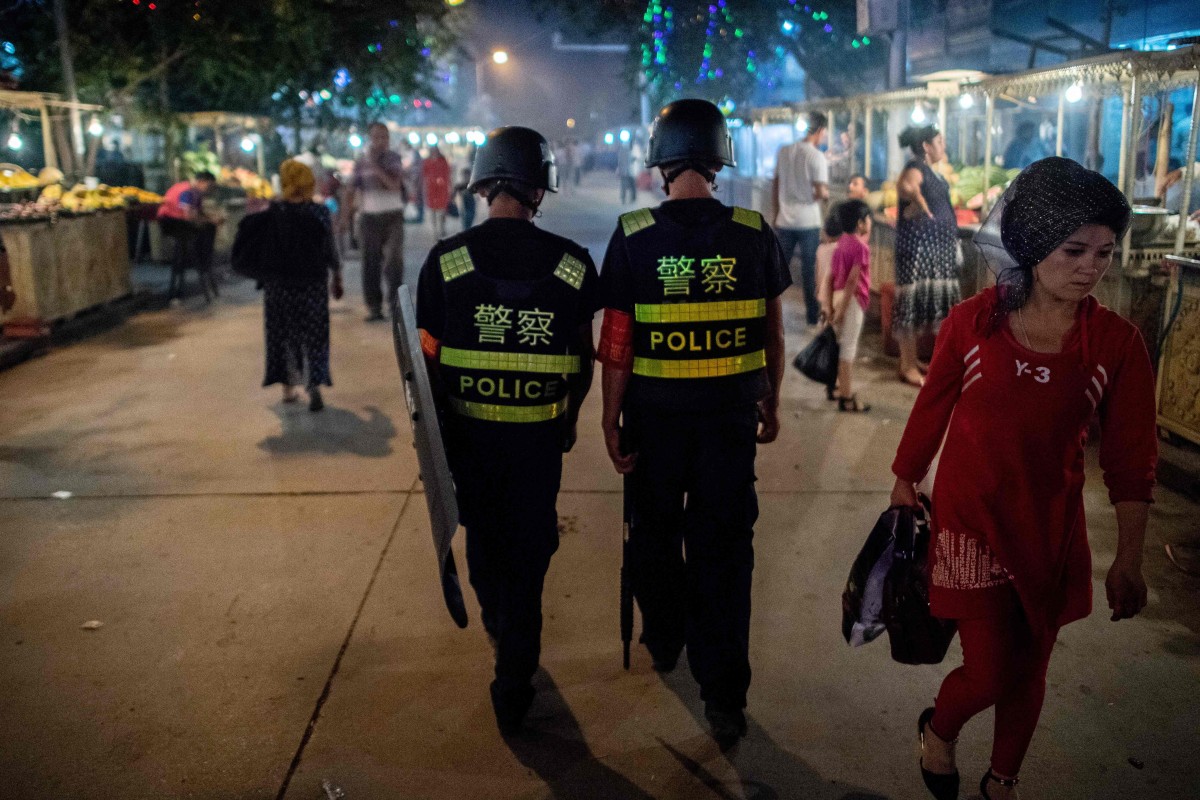 Police patrolling a food market near the Id Kah Mosque in Kashgar in China’s Xinjiang. Photo: AFP