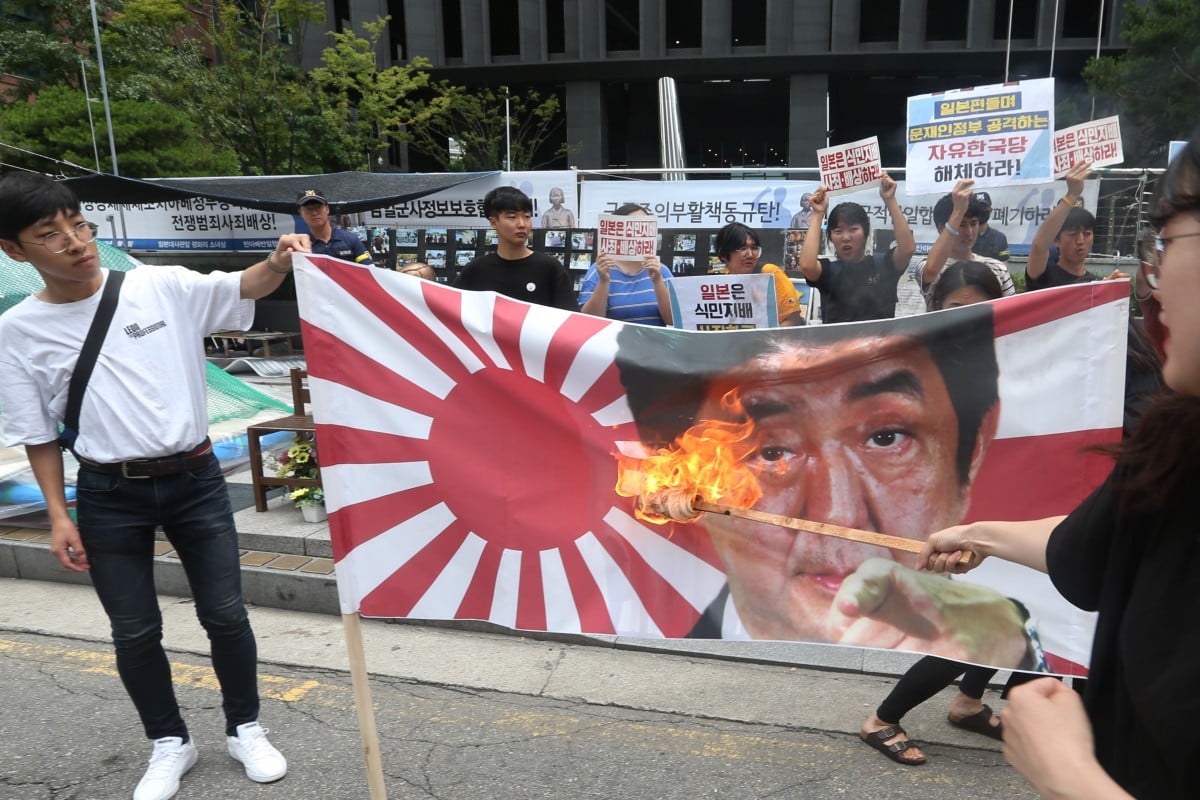 South Korean protesters burn portraits of Japanese Prime Minister Shinzo Abe near the Japanese embassy in Seoul. Photo: EPA-EFE