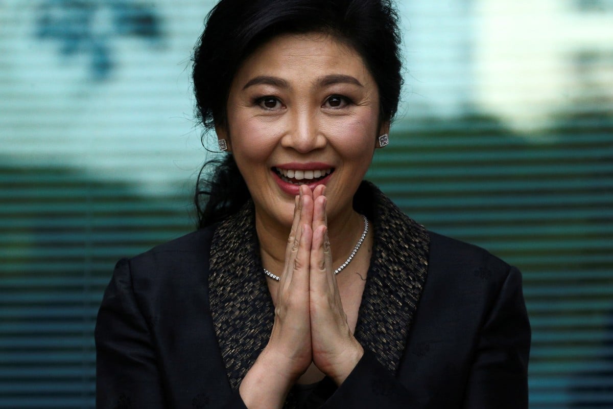 Former Thai prime minister Yingluck Shinawatra greets supporters as she arrives at the Supreme Court in Bangkok in August 2017. Photo: Reuters