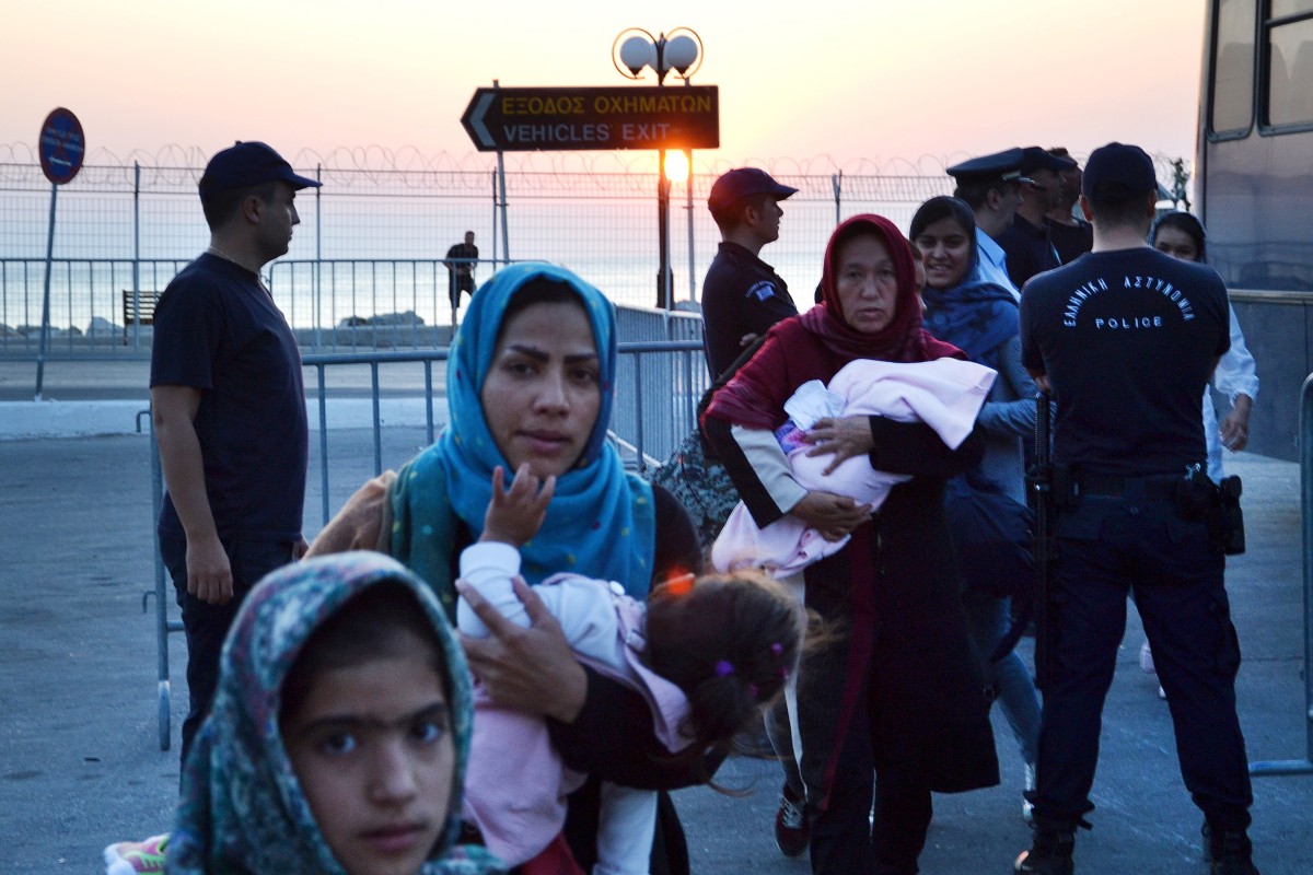 Refugees and migrants wait to be transferred from overcrowded Lesbos to mainland Greece on Monday. Photo: EPA