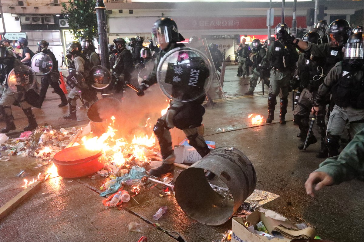 Riot police give chase as protesters throw petrol bombs in Causeway Bay on August 31. A leaked tape of Chief Executive Carrie Lam speaking to business leaders revealed a genuine desire to keep “one country, two systems” going in Hong Kong. Photo: Felix Wong
