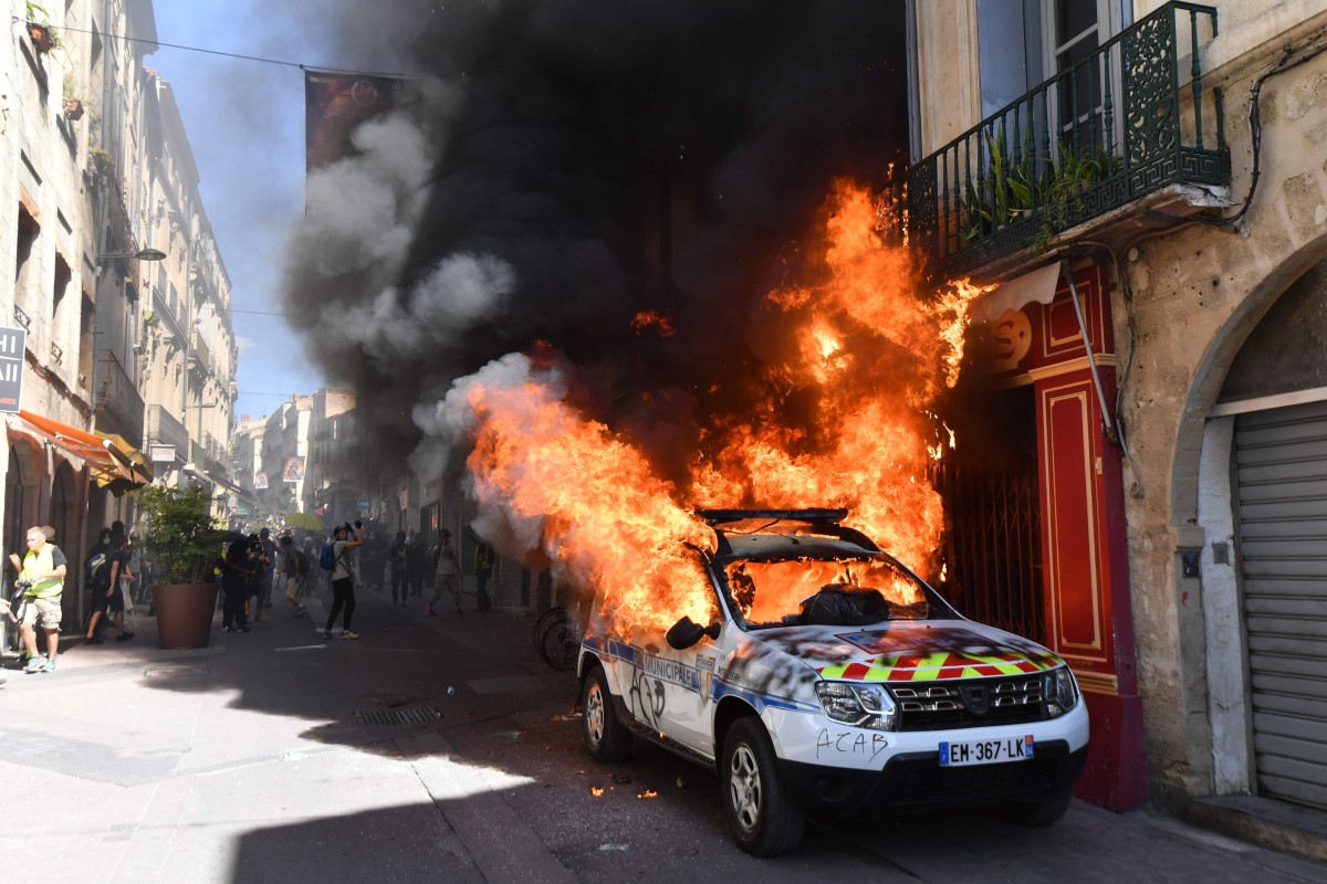 A police car burns on the sidelines of a yellow vest demonstration in Montpellier on Saturday. Photo: AFP