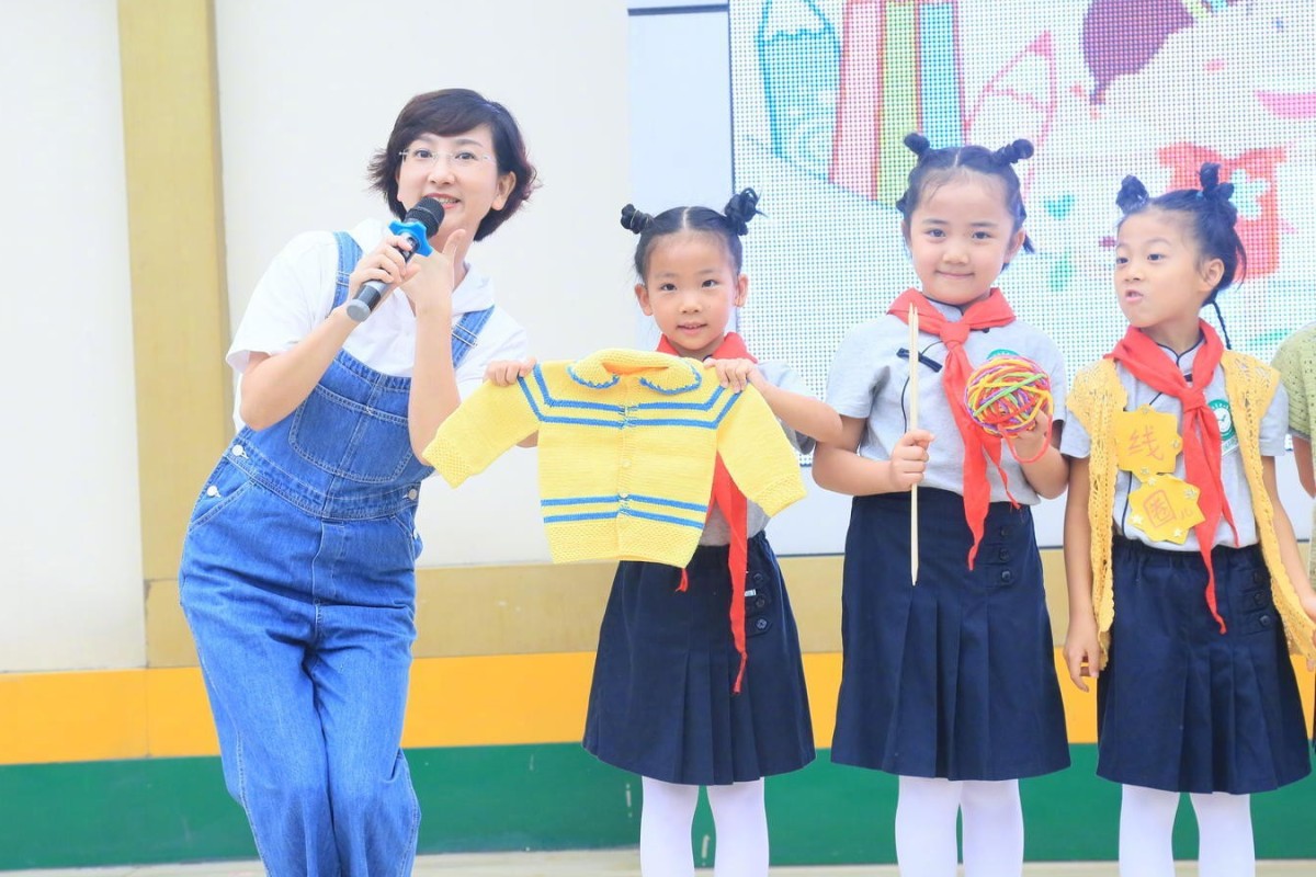 Pupils and staff at Chengdu Caotang Elementary School in Sichuan show off knitting from their Boys and Girls are Vastly Different class. Photo: Weibo