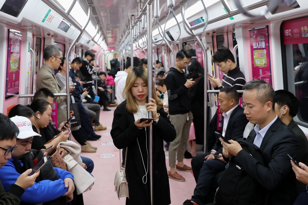 A woman is surrounded by men in a priority carriage on the Shenzhen metro. Photo: Sam Tsang