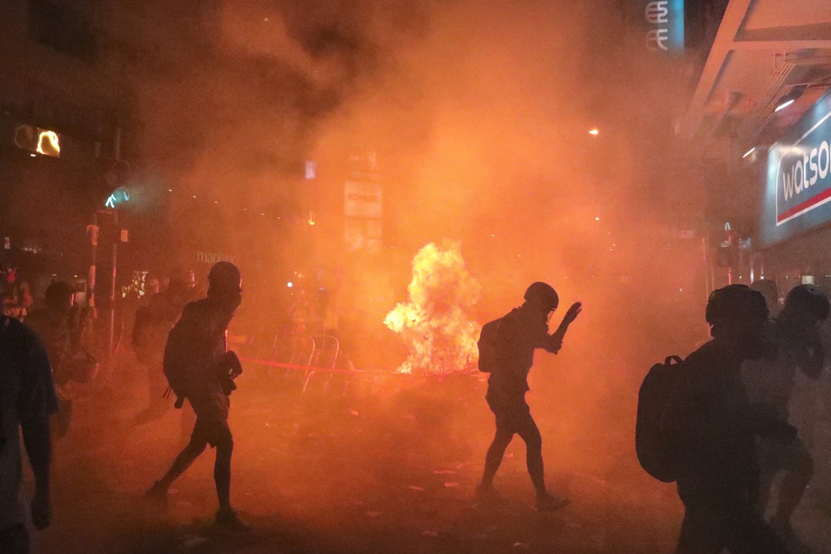 Police battle protesters as they set streets ablaze in central Hong