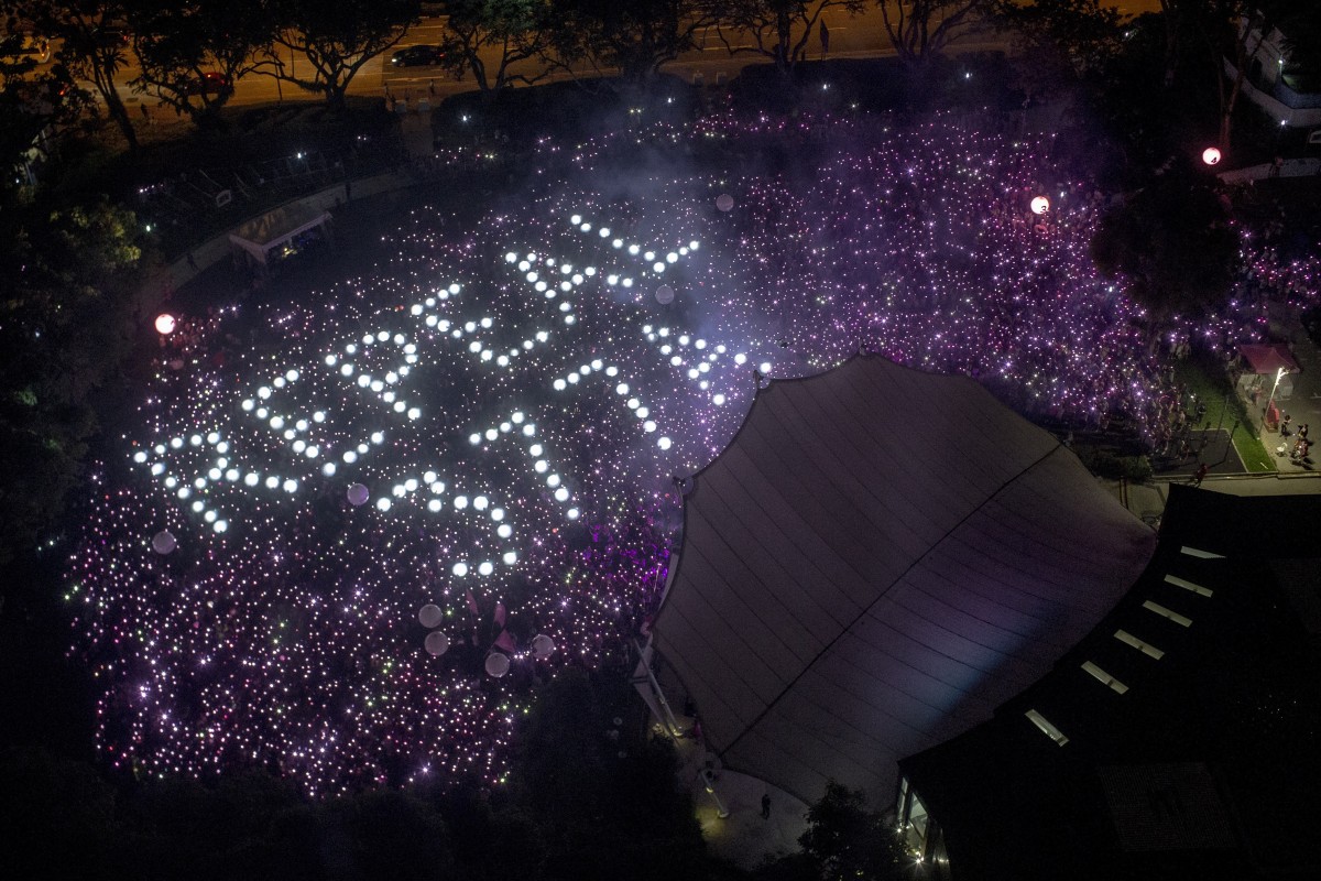 The words “Repeal 377A”, referencing a law that criminalises sexual acts between men, are formed by the crowd during the Pink Dot festival at Speaker's Corner in Hong Lim Park, Singapore, on June 29. Photo: EPA-EFE