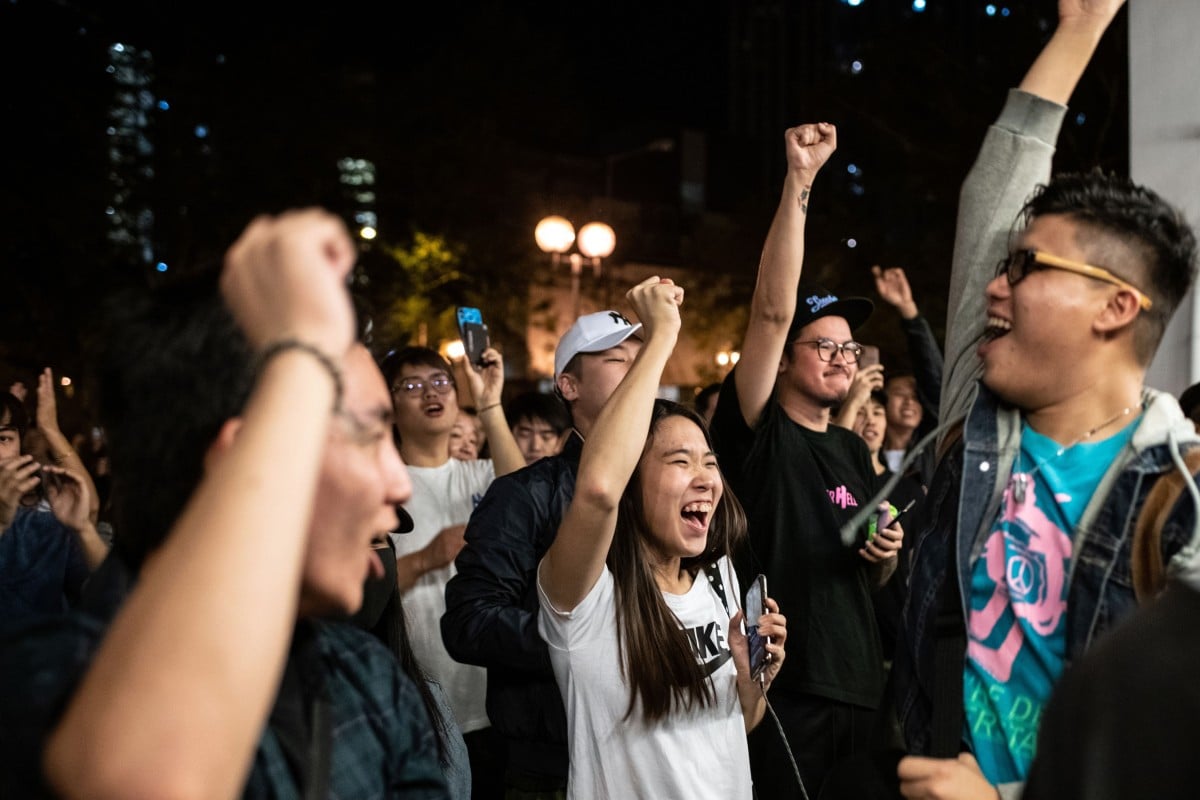 Pro-democracy supporters celebrate the defeat of Junius Ho Kwan-yiu, one of the most high-profile victims of Sunday’s vote. Photo: AFP