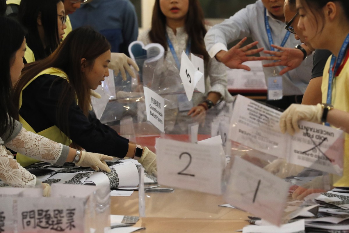 Officials count ballots at a polling station in Hong Kong. Photo: EPA