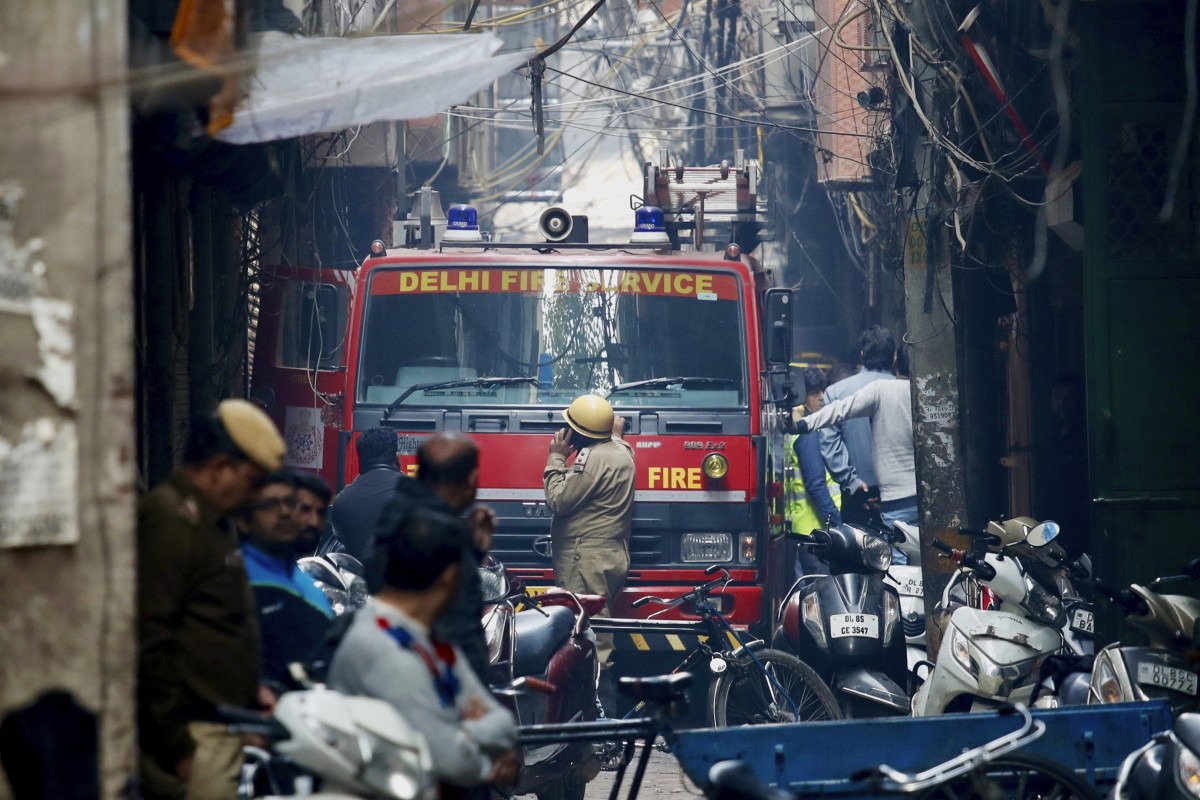 A fire engine in an alleyway, tangled in electrical wire and too narrow for vehicles to access, in New Delhi. Photo: AP