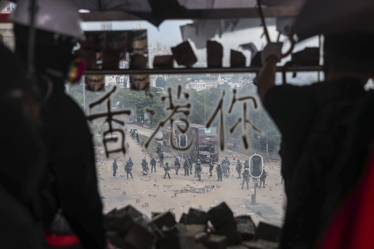 Anti-government protesters set up roadblocks outside City University during clashes with police. Photo: Sam Tsang