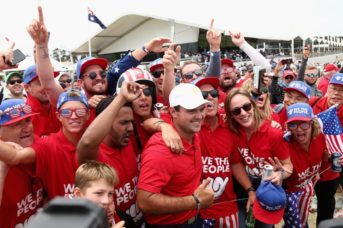 Patrick Reed (centre) of the USA team celebrates with fans during the final day of action. Photo: EPA