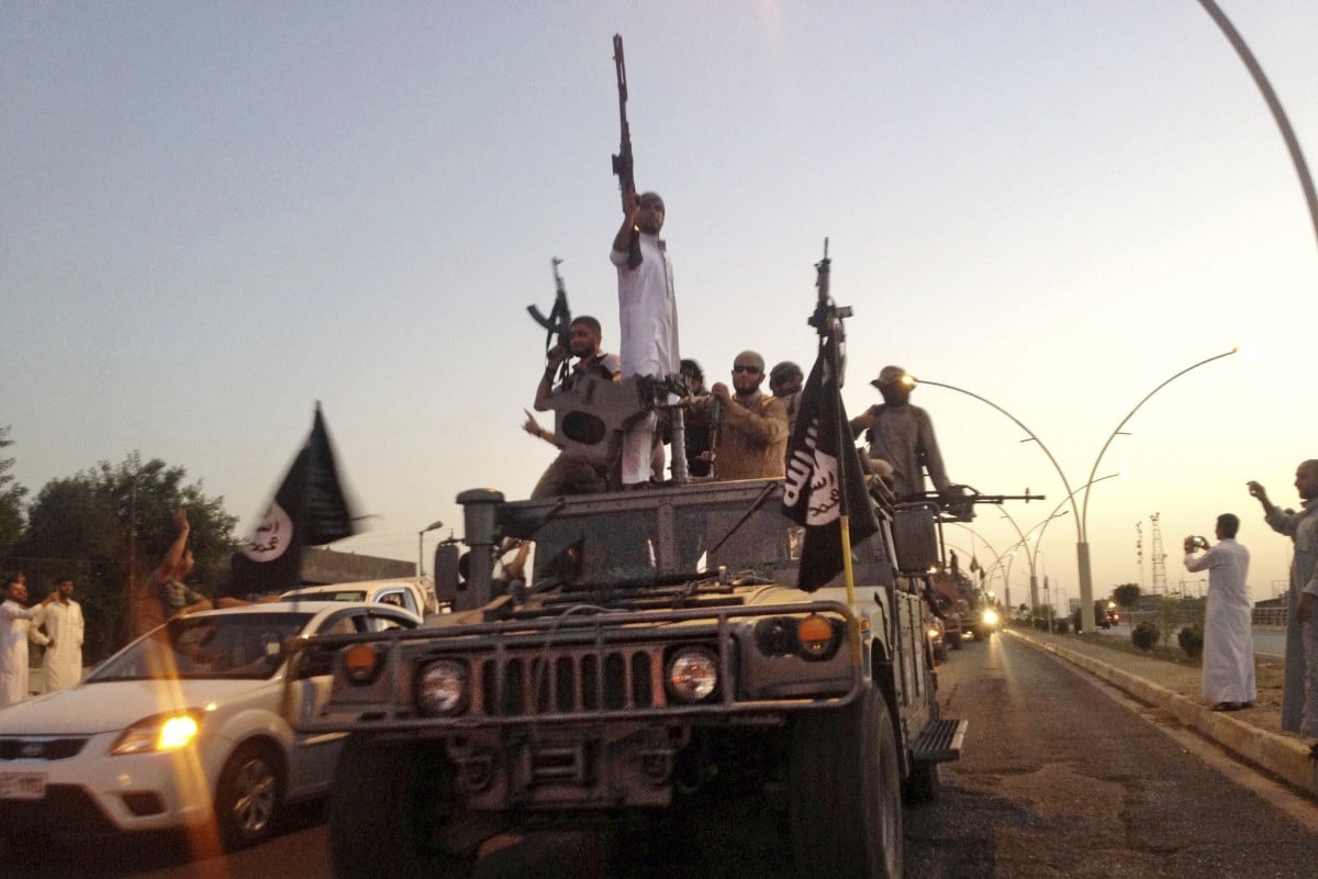 Islamic State fighters in a commandeered Iraqi security forces armoured vehicle in 2014. Photo: AP