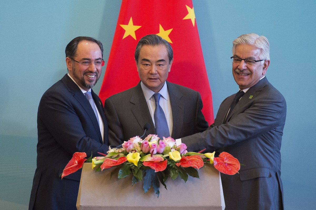 Afghanistan’s Foreign Minister Salahuddin Rabbani, China’s Foreign Minister Wang Yi (centre), and Pakistan’s Foreign Minister Khawaja Muhammad Asif join hands after a joint dialogue in 2017. Photo: AFP