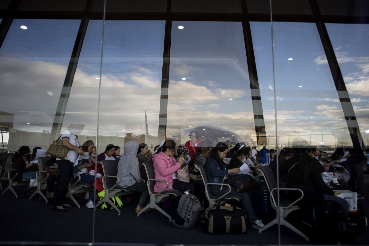 Filipino workers arrive at Manila International Airport after a flight from Kuwait. Photo: AFP