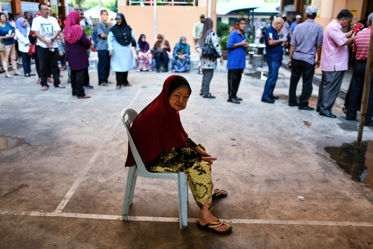 An elderly Malaysian woman waits to cast her vote in Kuala Lumpur during the 2018 general election. Photo: AFP