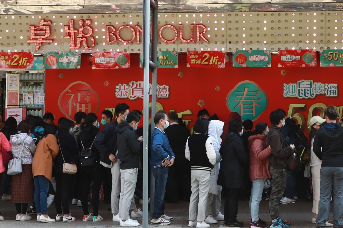 People queue for masks outside Bonjour shop in Mong Kok. The government has announced 32 million masks for public use are on the way. Photo: May Tse