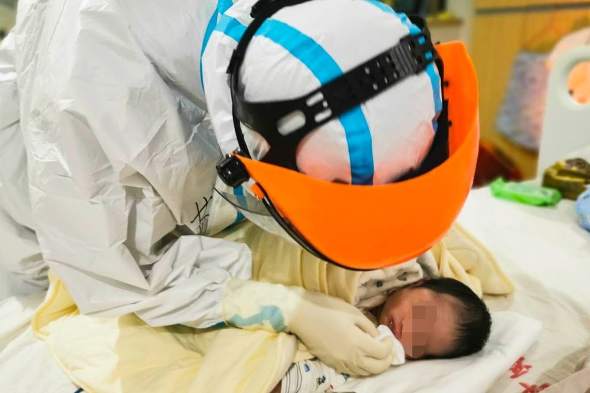 A doctor cares for a child whose mother contracted Covid-19 at a hospital in China’s Hubei province. The baby did not show any signs of the disease. Photo: Xinhua