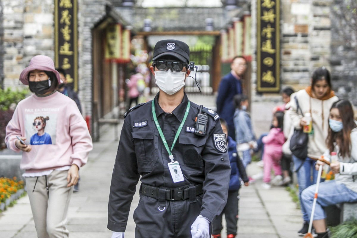 A roving security staff member at Hongyuan Park, part of the Xixi Wetland preserve in Hangzhou in eastern China, wears a pair of smart glasses from artificial intelligence start-up Rokid to check on the temperature of park visitors. Photo: Handout