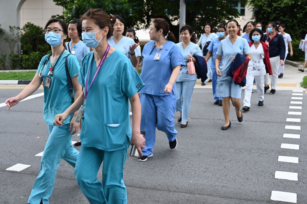 Medical staff walk to the National Centre for Infectious Diseases building at Tan Tock Seng Hospital in Singapore. Photo: AFP