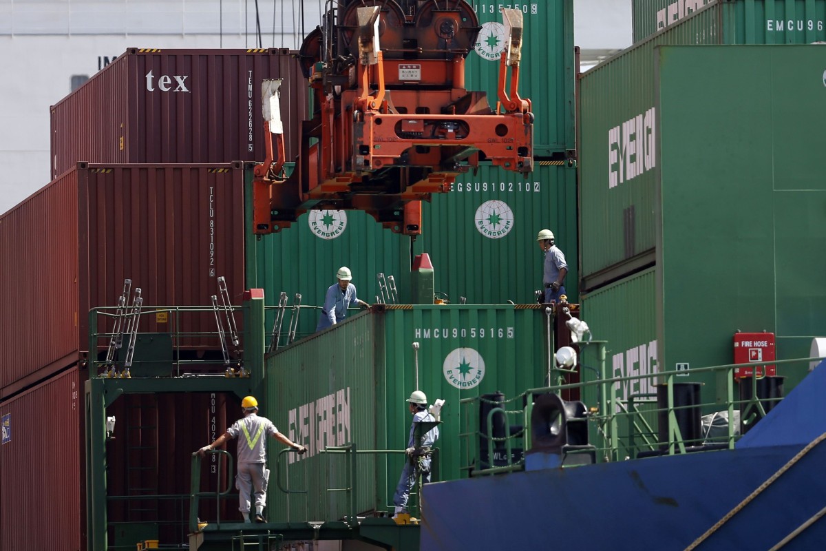 Crew watch as a container is loaded on to a cargo ship in Tokyo. The International Chamber of Shipping estimates that at least 100,000 seafarers a month need to change over from the ships they work on. Photo: Reuters