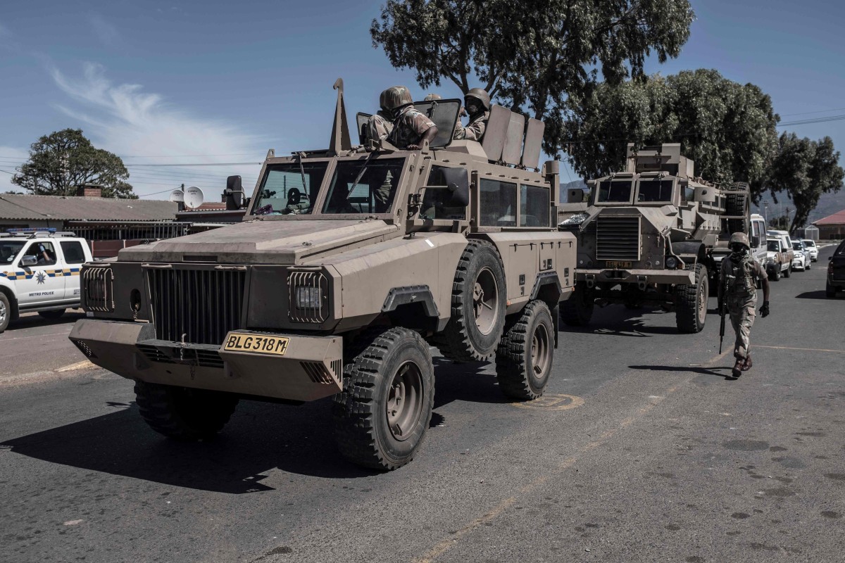 South African National Defence Force soldiers drive in an armoured personnel carrier in Cape Town on Monday. Photo: AFP