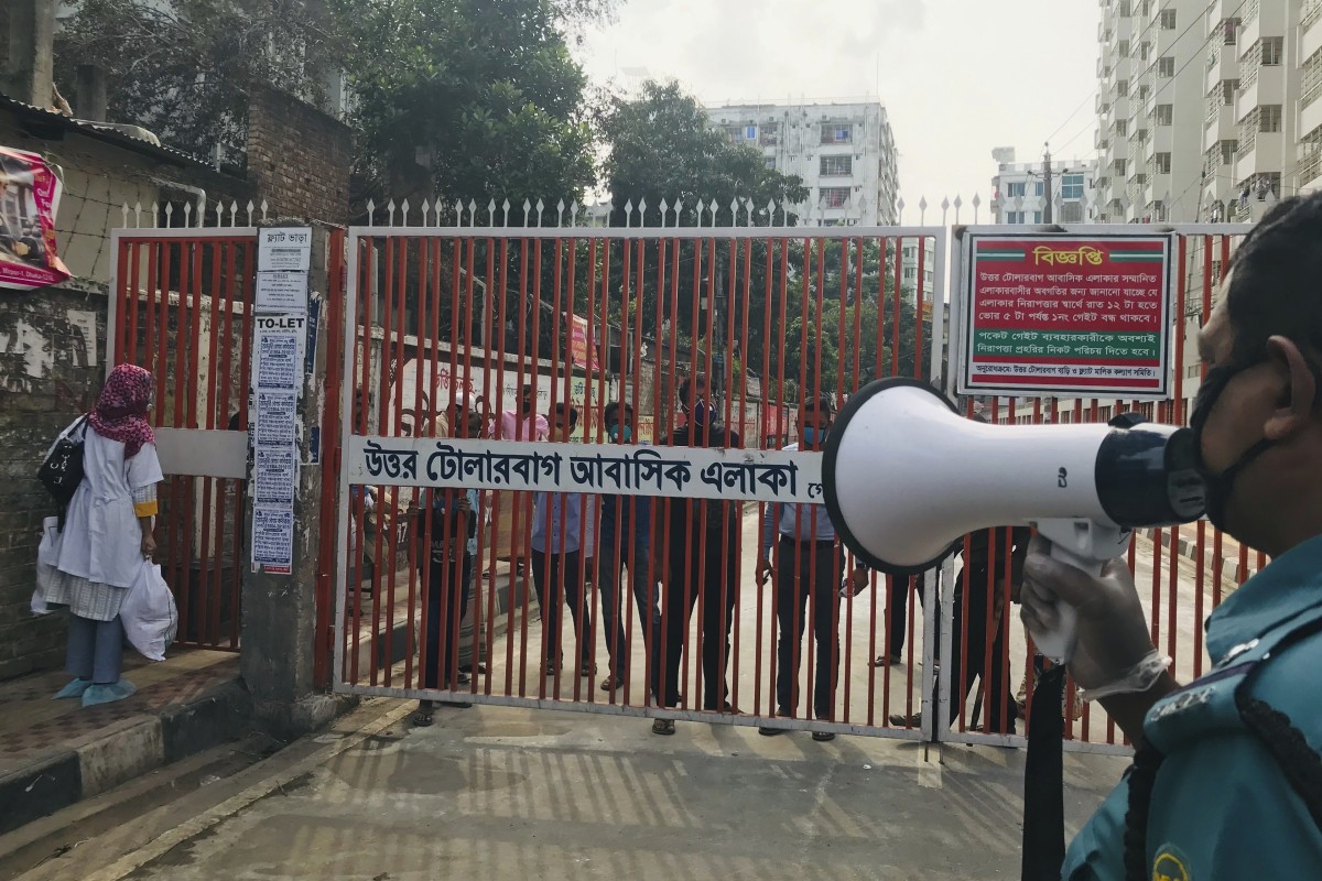 A policeman urges residents not to come out of their homes in Dhaka, Bangladesh, last week. Photo: AP