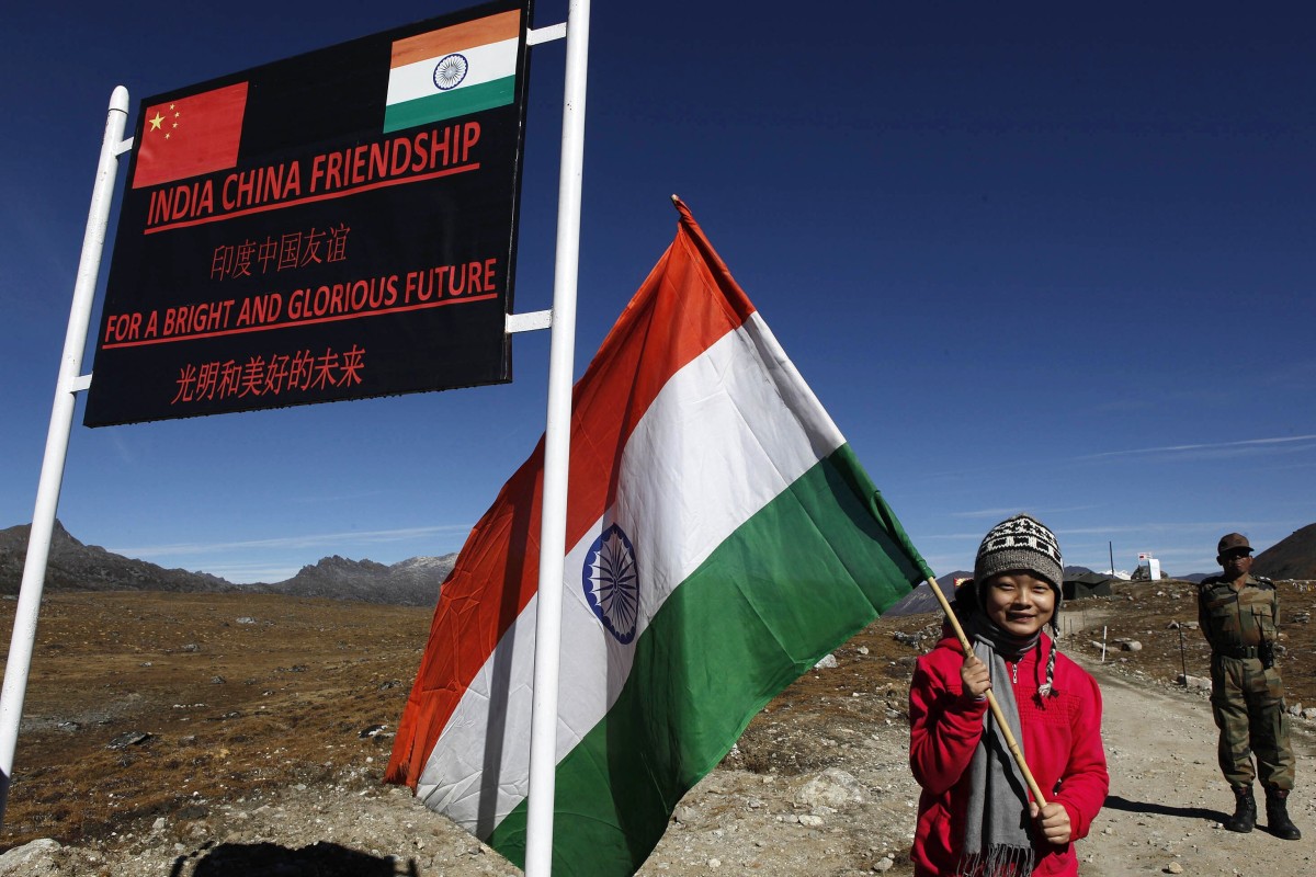 An Indian girl poses for photographs with an Indian flag at the Indo-China border in Arunachal Pradesh. Photo: AP