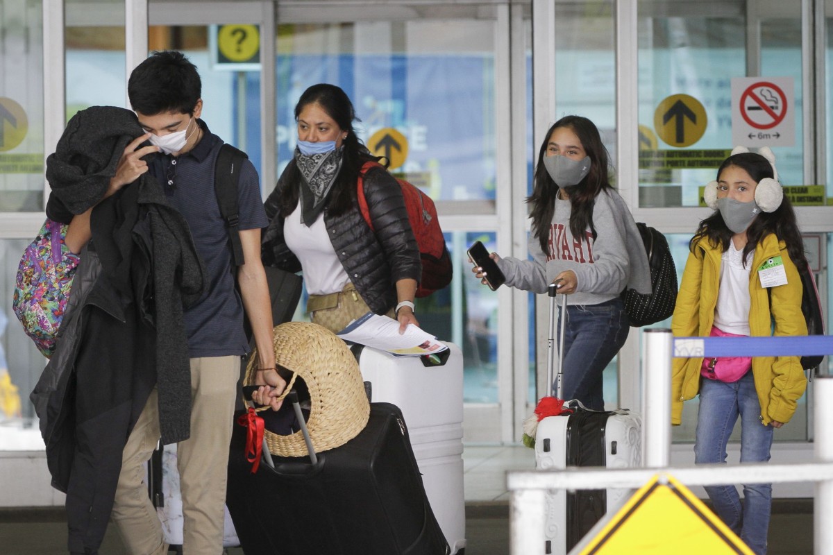 Travellers wearing face masks arrive at Vancouver International Airport in Richmond on April 20. Photo: Xinhua