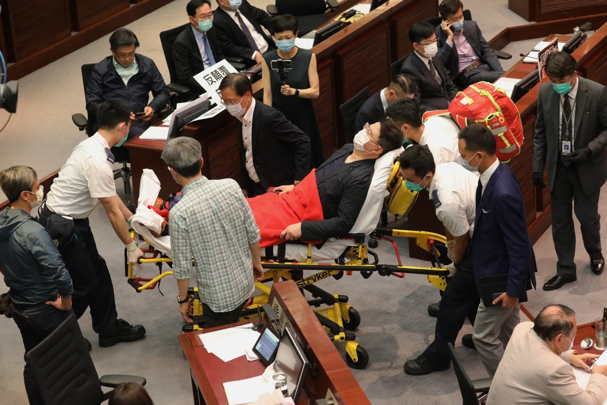 Lawmaker Andrew Wan is carried out by medical staff in Legco as chaos breaks out. Photo: Dickson Lee