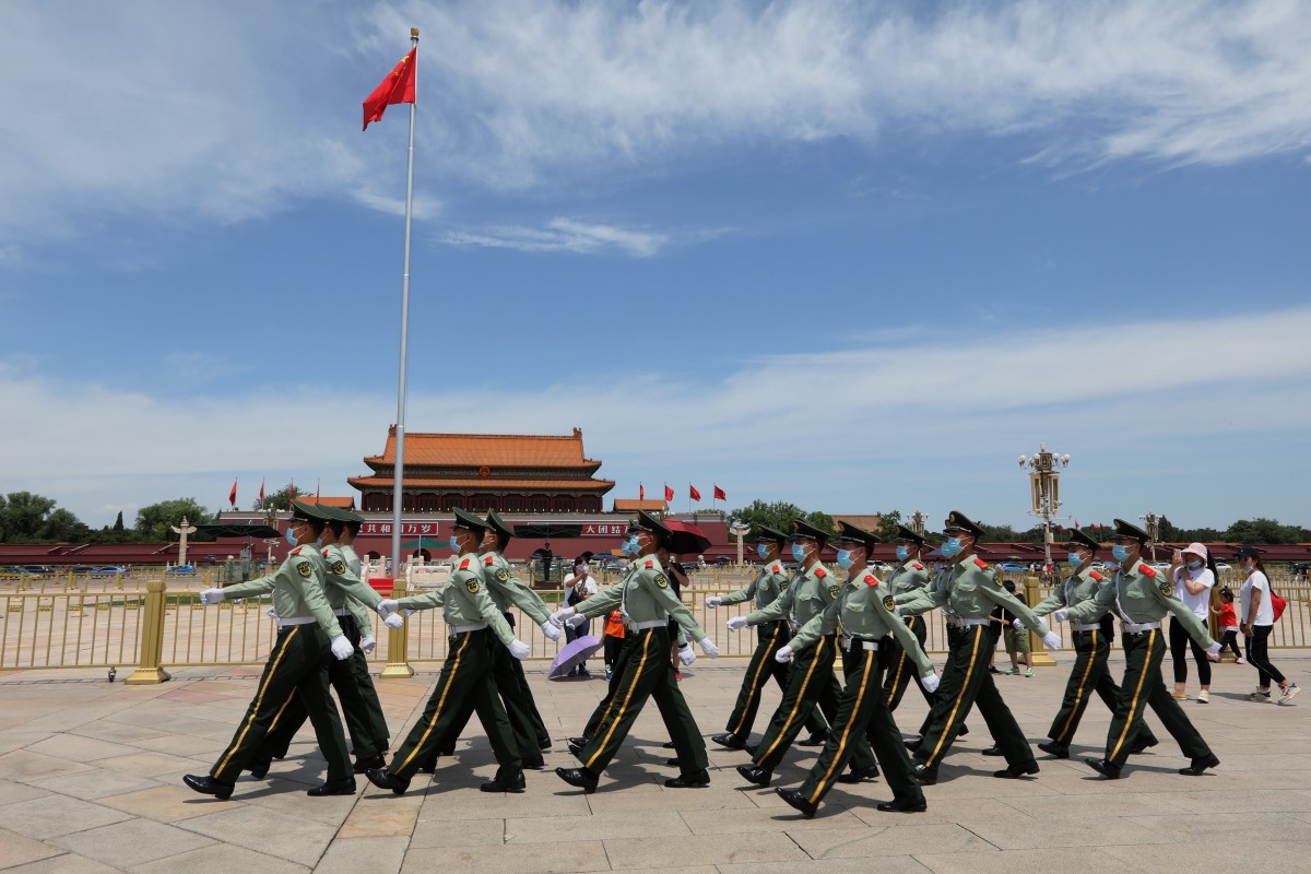 Armed policemen walk through Tiananmen Square in Beijing, ahead of the start of this year’s two sessions. Photo: Simon Song