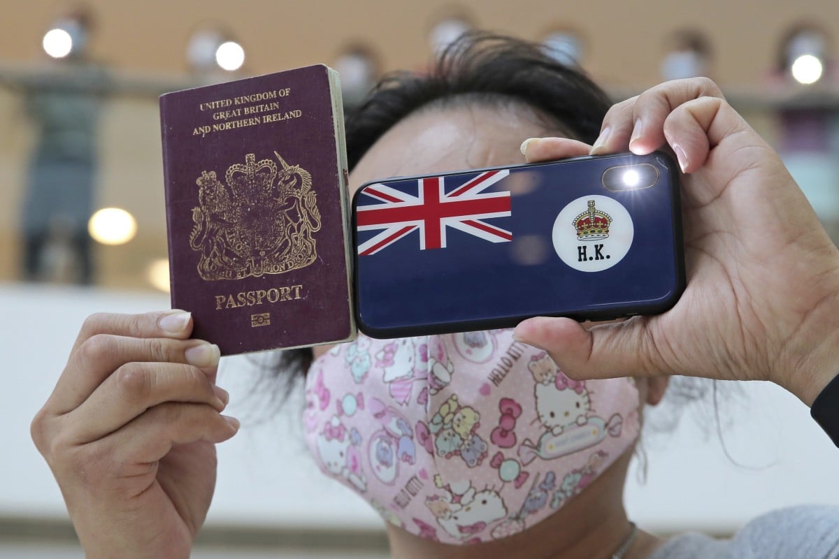 A protester in Hong Kong holds a British National (Overseas) passport during a protest against China’s national security legislation for the city. Photo: AP