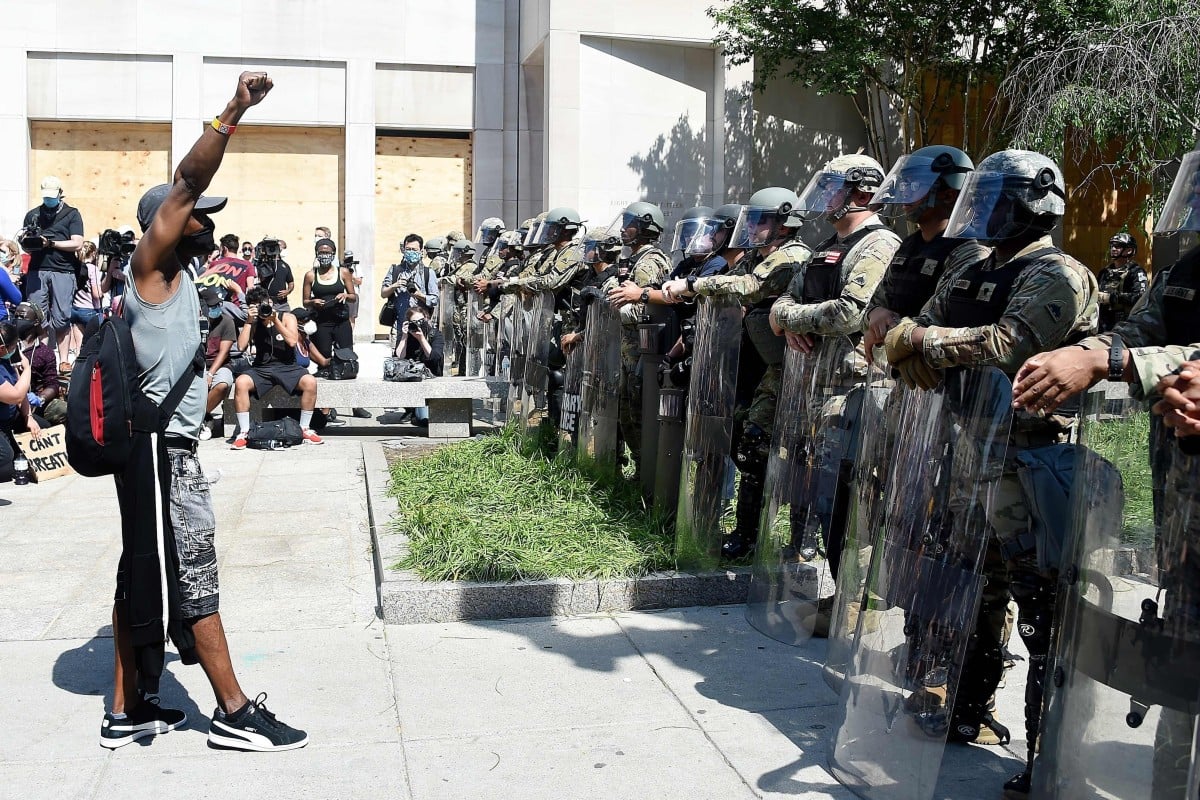 A protester on Wednesday faces military police near the White House in Washington to protest the death of George Floyd. Photo: AFP
