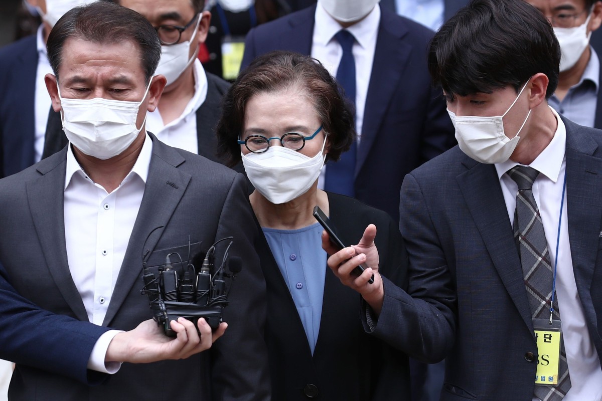 Lee Myung-hee (centre) leaves court after her trial in Seoul. Photo: Yonhap/AFP
