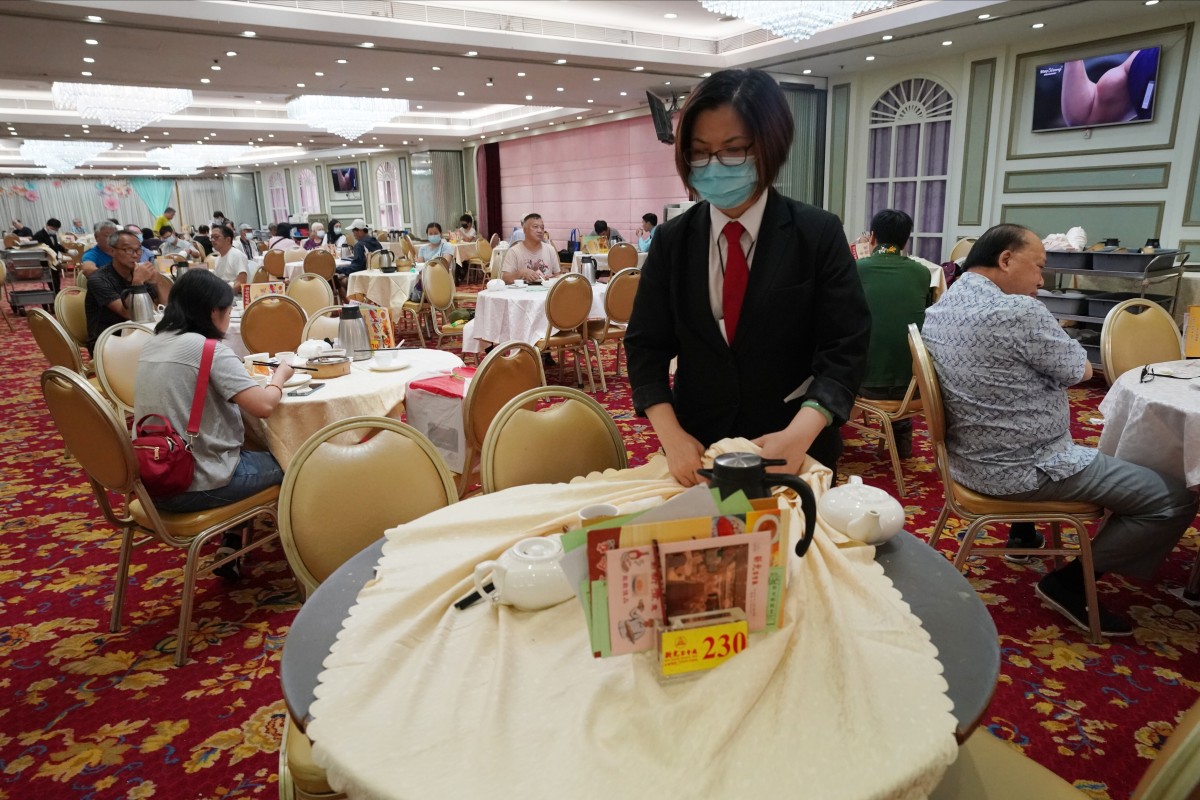 A staff member clears a table at a restaurant in Aberdeen on July 28. Some studies suggest social distancing at less than 2 metres can still be safe, raising hopes restaurants and other indoor venues can remain open for business during the pandemic. Photo: Felix Wong