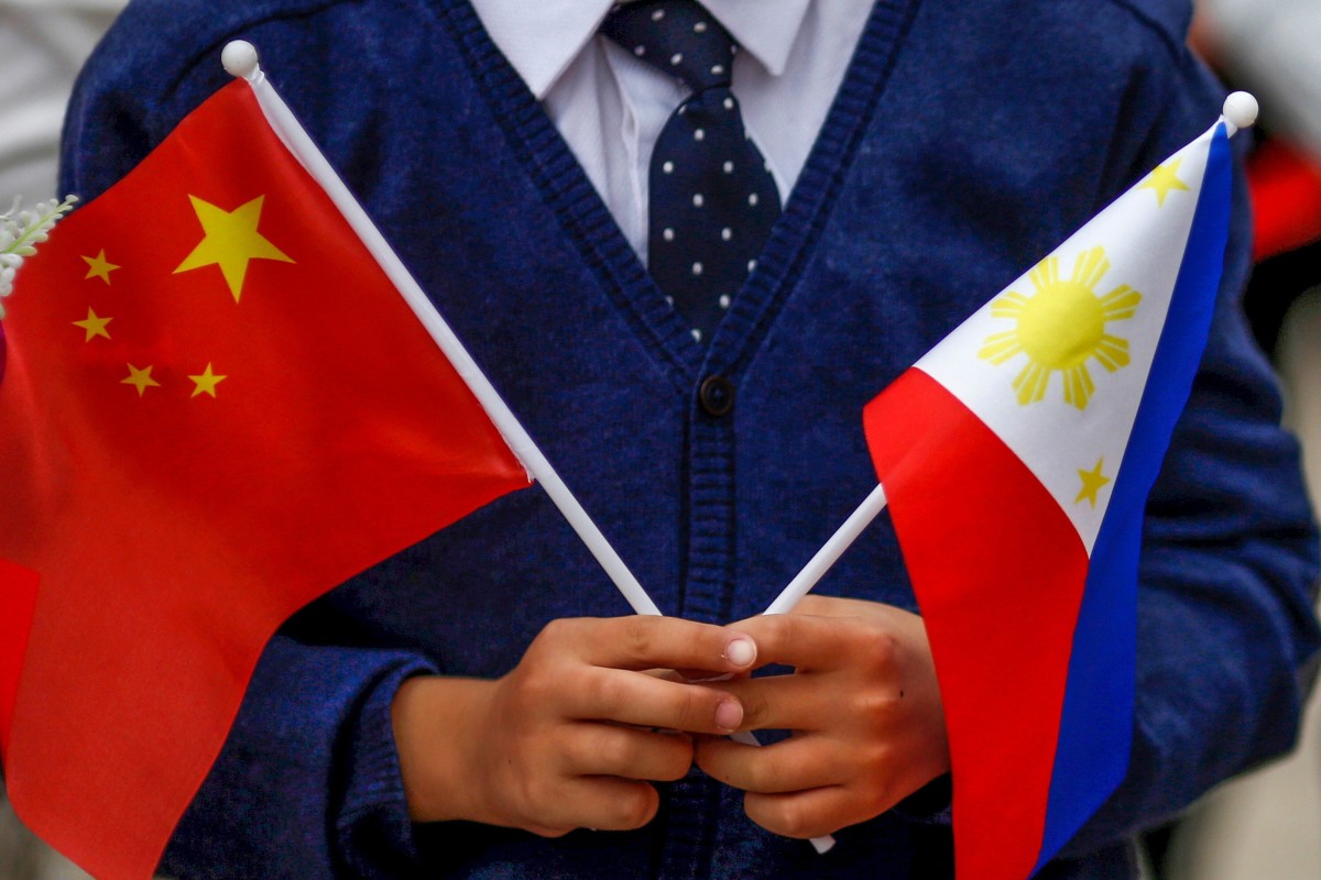 A child holds the national flags of China and the Philippines during President Rodrigo Duterte’s visit to Beijing in October 2016. Photo: Reuters