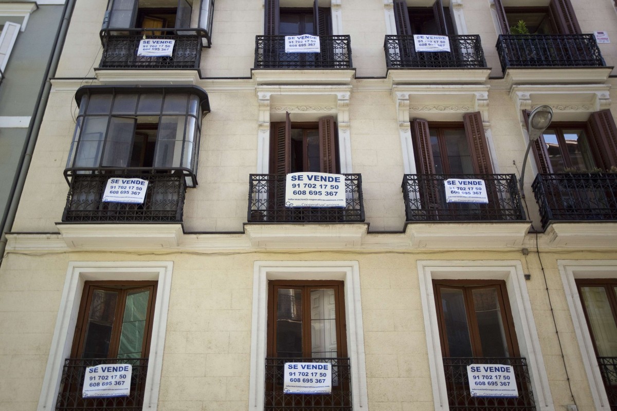Signs saying “For Sale” hang on the balconies of a flat block in central Madrid. Spain ranks highly as a relocation choice among homebuyers surveyed by Knight Frank. Photo: Reuters