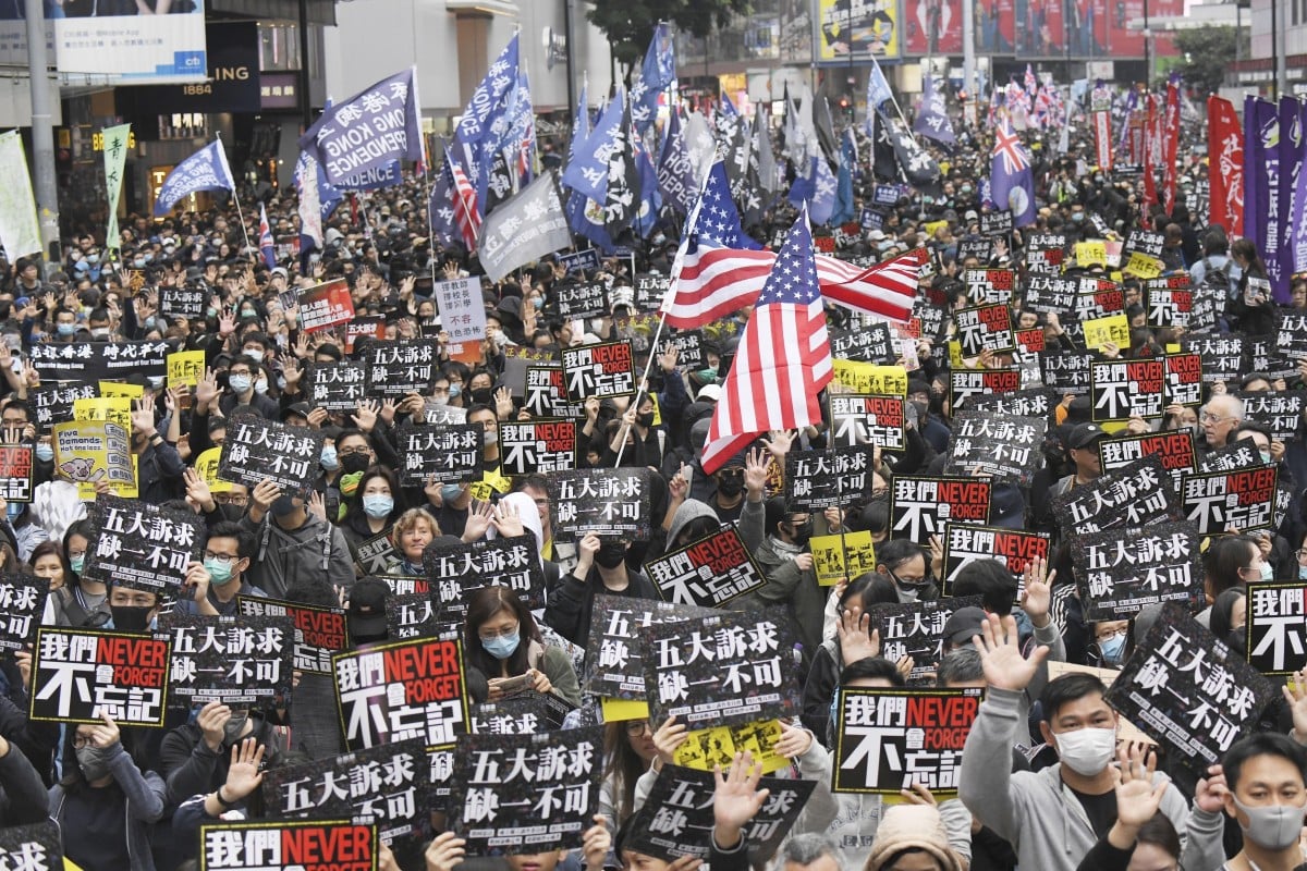 Tens of thousands of anti-government protesters march in central Hong Kong on January 1 as they continue to pressure the government to meet their five demands, including greater democracy, amnesty for arrested protesters and an independent inquiry into police use of force. Photo: Kyodo