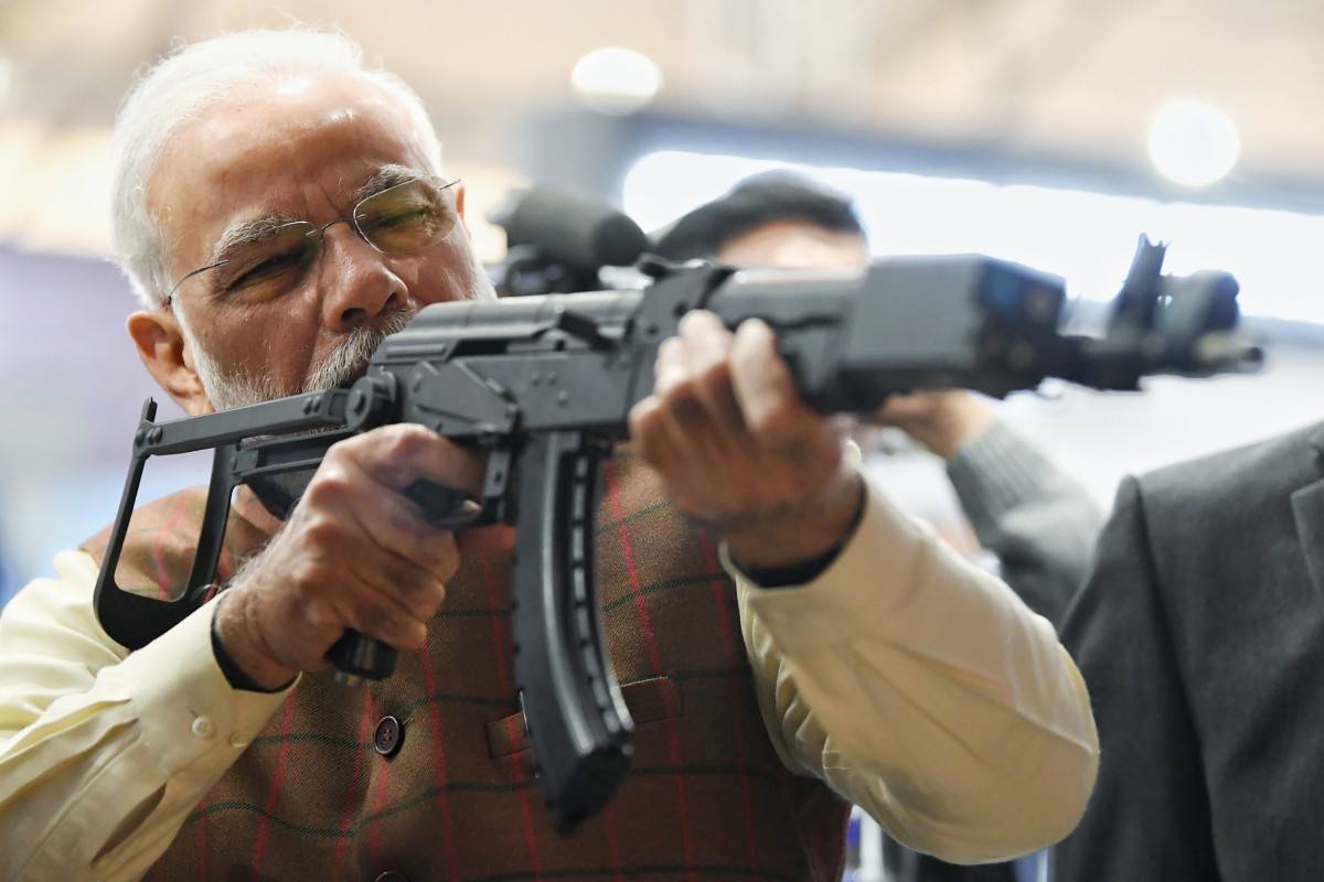 Indian Prime Minister Narendra Modi holds a rifle during a defence expo in February. The country is looking to import military equipment amid tensions with its neighbours, despite plans to boost its own defence industry. Photo: AP