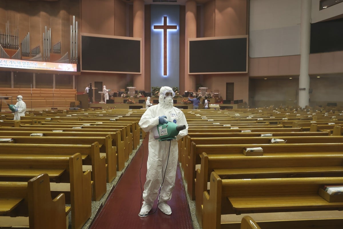 Public officials disinfect a church in South Korea. Photo: AP