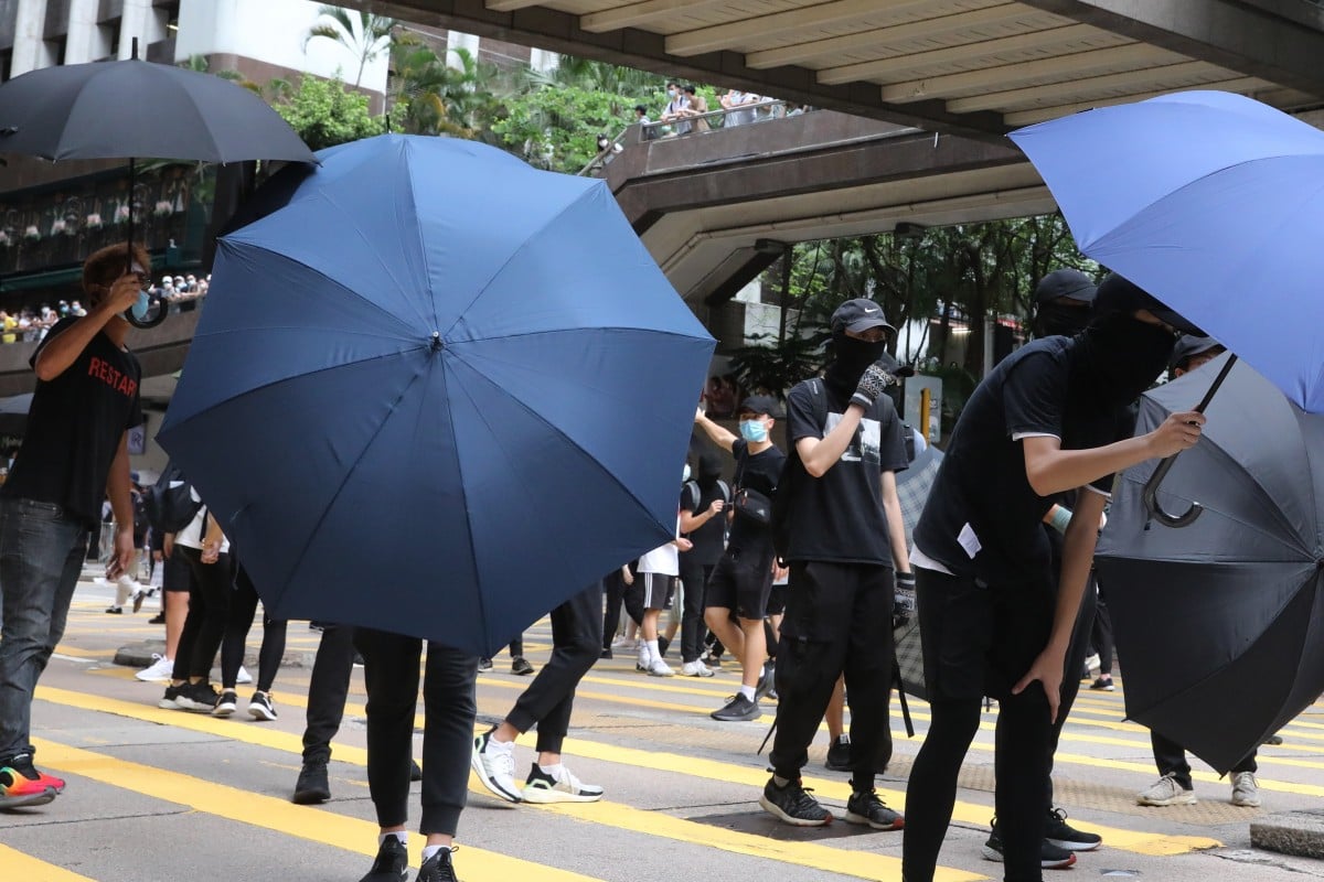 Anti-government protesters open their umbrellas as police approach during an unlawful demonstration on July 1, the anniversary of Hong Kong’s handover from British to Chinese sovereignty. Photo: K. Y. Cheng