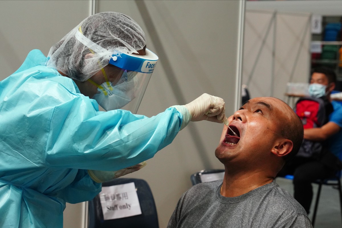 A Hong Kong resident undergoes a Covid-19 test at Queen Elizabeth Stadium in Wan Chai. Photo: Sam Tsang