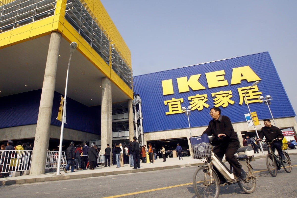 Customers cycle past a newly-opened Ikea store in Chengdu, China, on November 29, 2006. Photo: AFP