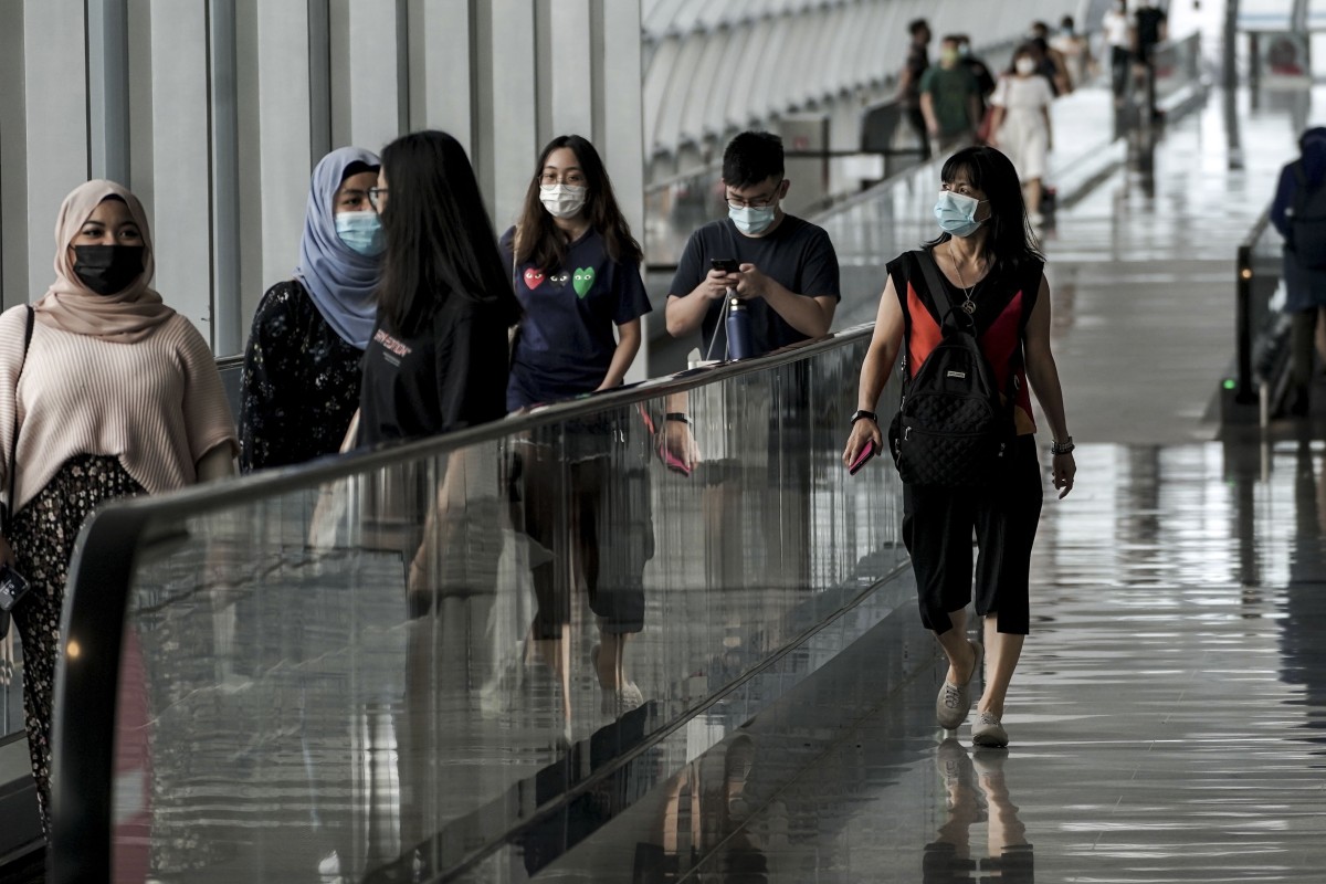 Travellers at Singapore’s Changi Airport, which has been servicing only a fraction of its usual traffic due to the coronavirus pandemic. Photo: EPA